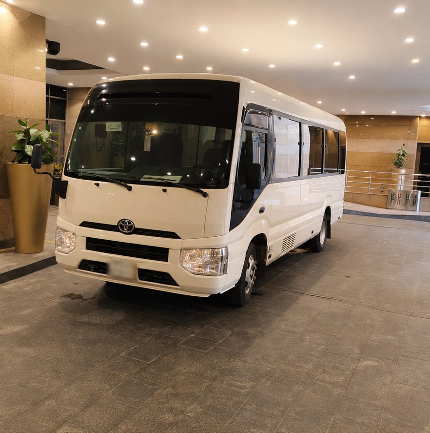 Toyota Coaster bus side view for Ziyarat tours
