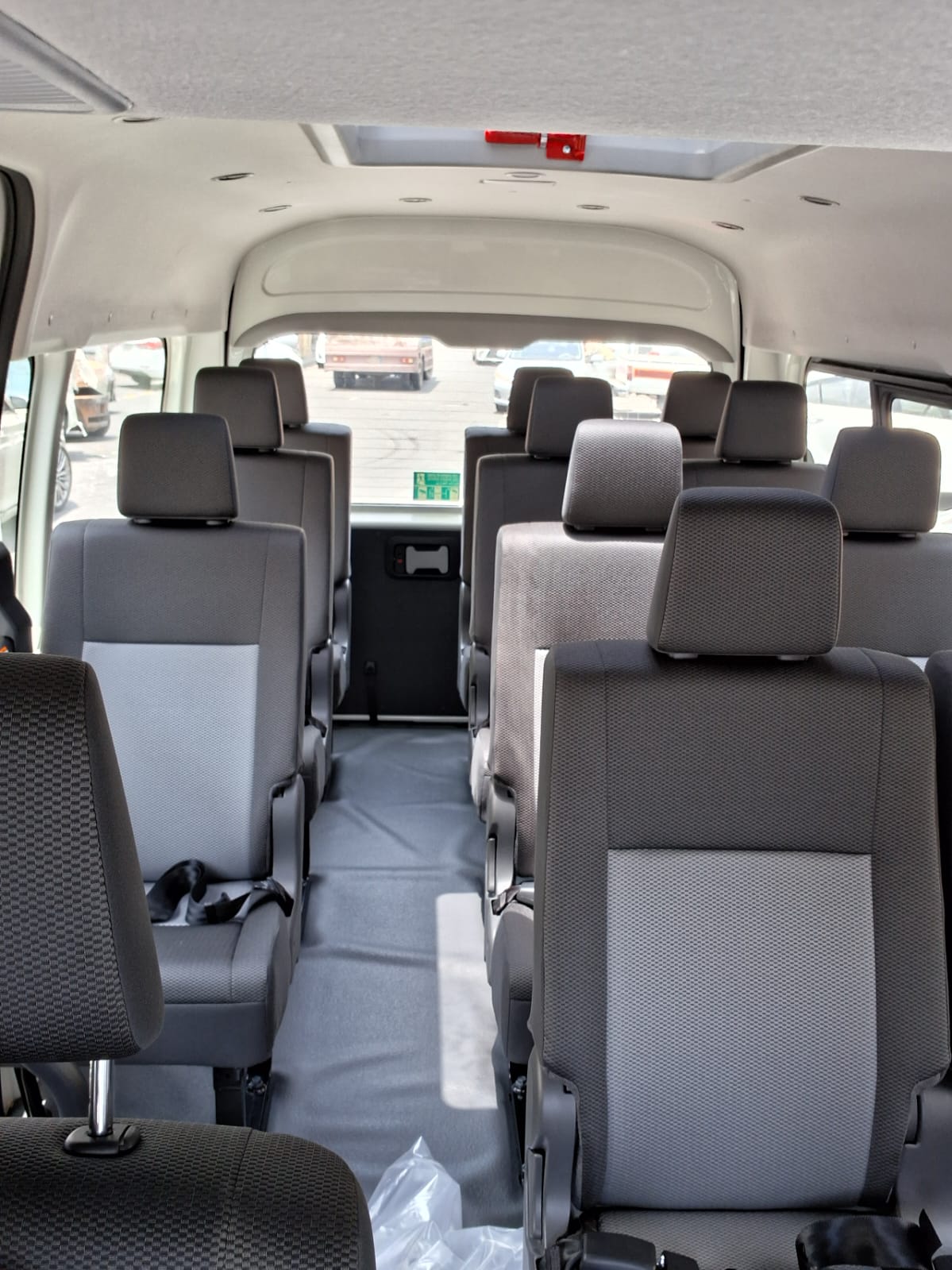 Interior seating and aisle of the Toyota HiAce group van